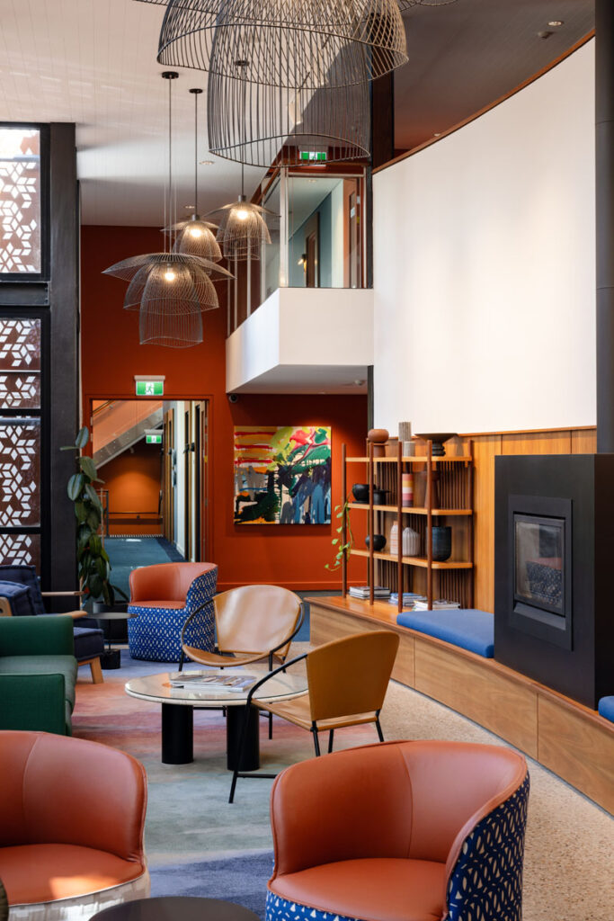 Modern lounge with leather and fabric armchairs and pendant lights